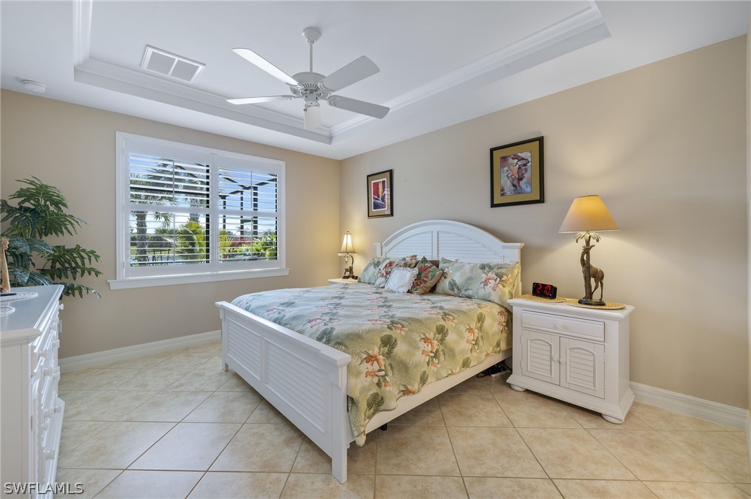 10845 Dennington Road Fort Myers, FL 33913 - Photo 10 of 46 a bedroom with a bed and a chandelier