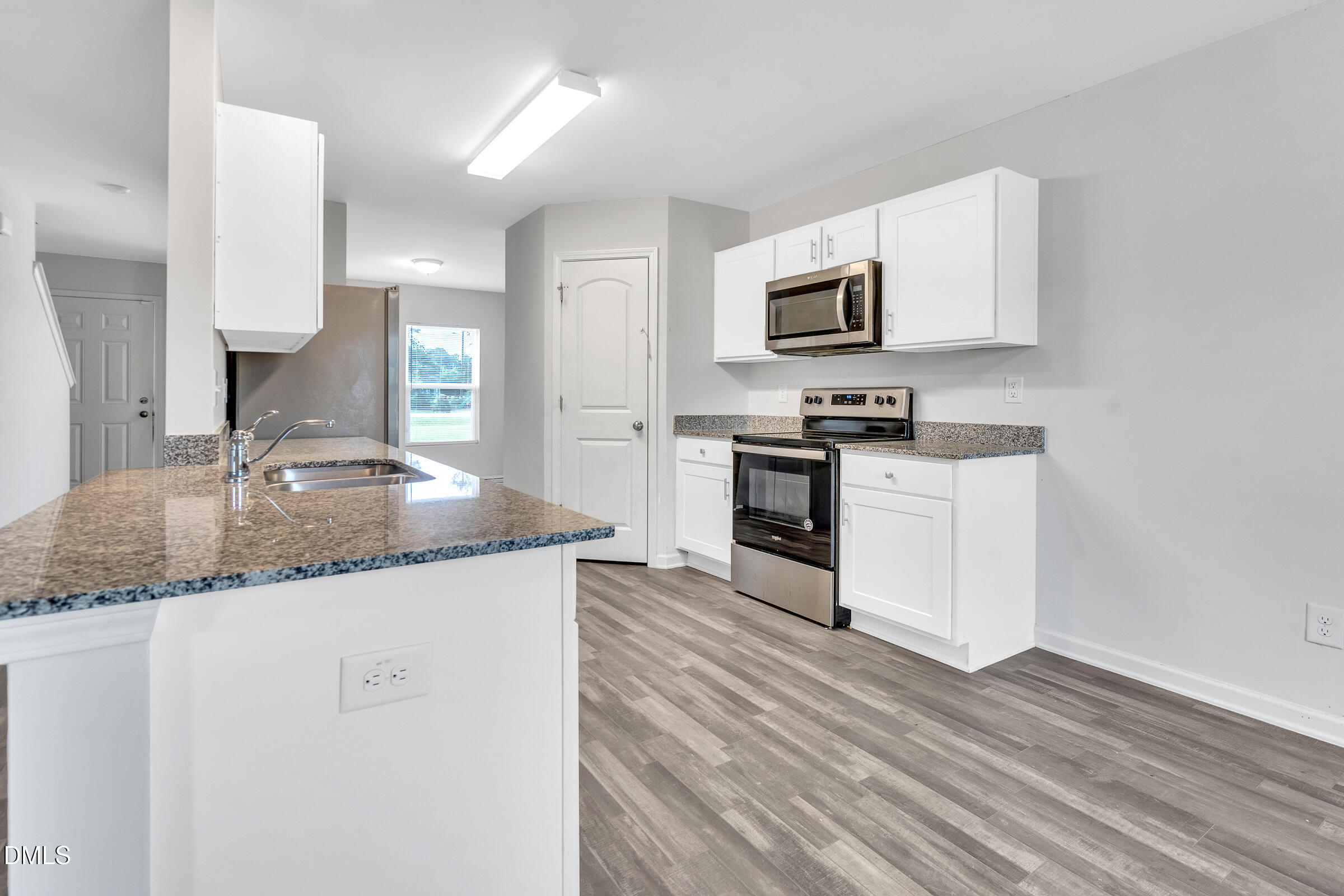 3146 Stoney Hill Church Road Bailey, NC 27807 - Photo 5 of 26 a kitchen with stainless steel appliances granite countertop a sink stove and microwave