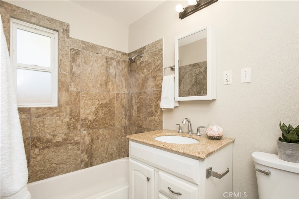 634 Willow Drive Brea, CA 92821 - Photo 20 of 26 a bathroom with a granite countertop sink a toilet and shower