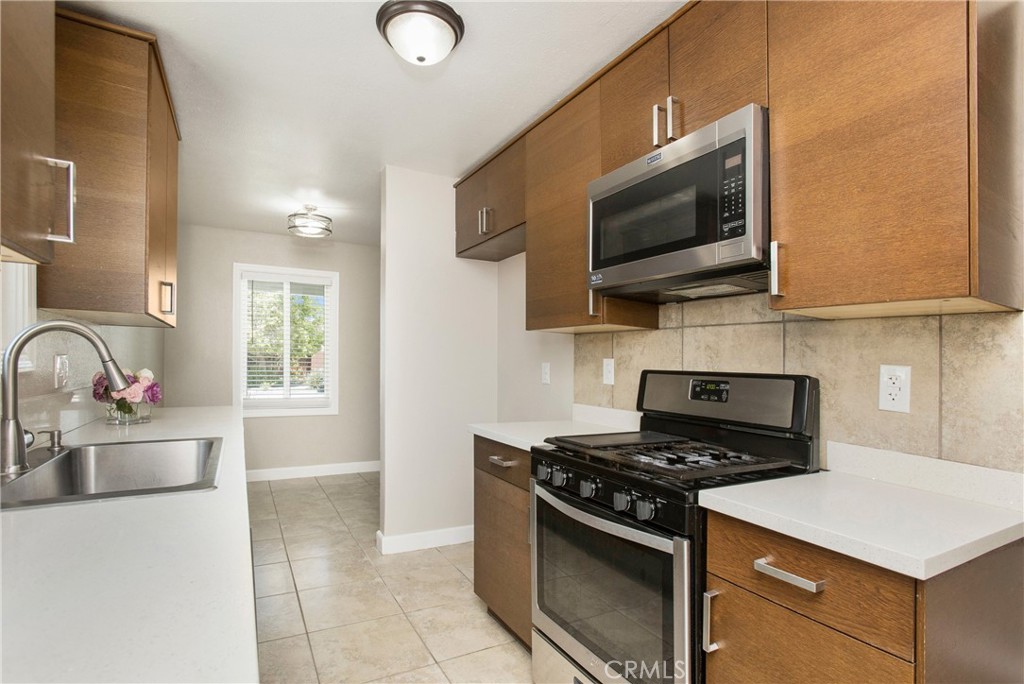 634 Willow Drive Brea, CA 92821 - Photo 2 of 26 a kitchen with stainless steel appliances a stove a microwave a sink and cabinets