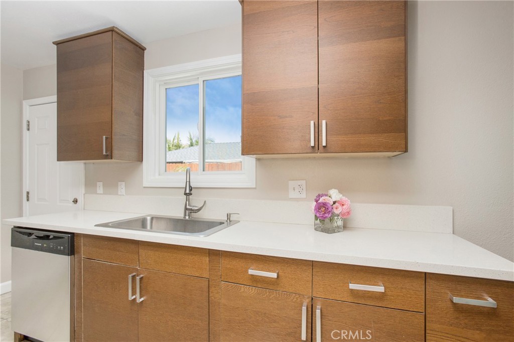 634 Willow Drive Brea, CA 92821 - Photo 4 of 26 a kitchen with stainless steel appliances granite countertop a sink dishwasher and cabinets with wooden floor