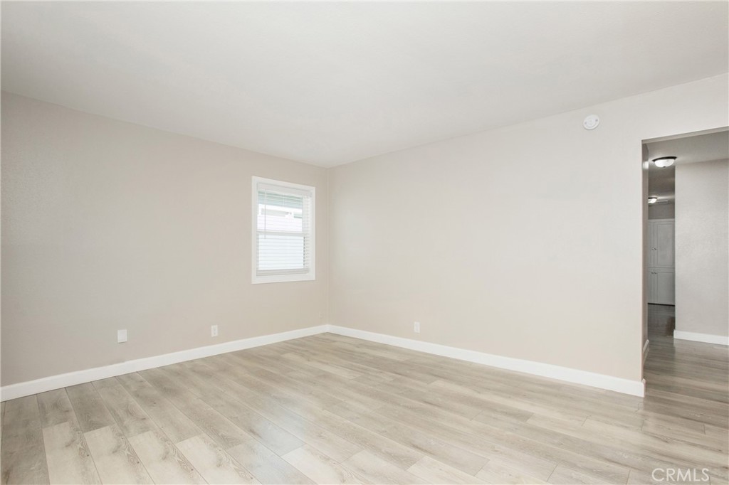 634 Willow Drive Brea, CA 92821 - Photo 7 of 26 an empty room with wooden floor and window