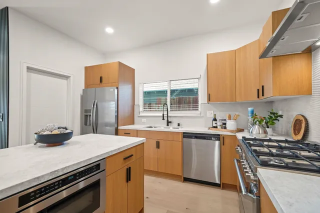 a kitchen with a sink stove and cabinets
