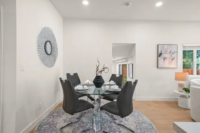 a dining room with furniture a rug and wooden floor