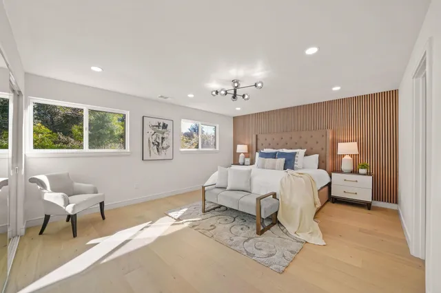 a bed room with a bed and a chair