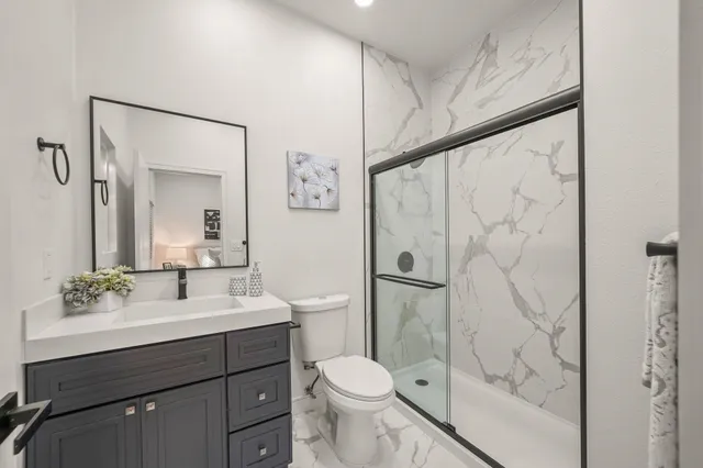 a bathroom with a sink toilet and shower