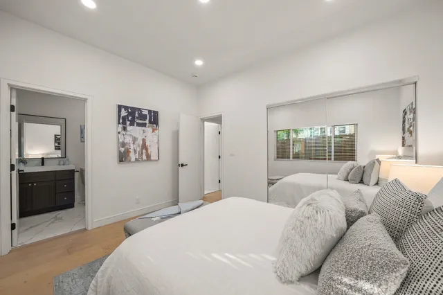 a bedroom with a large bed and a couch