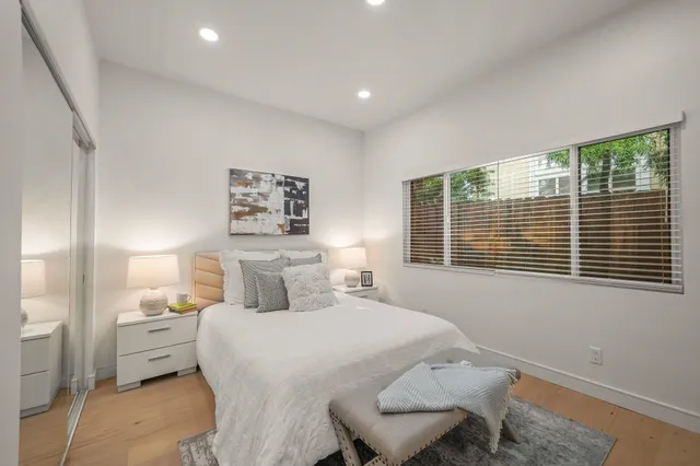 a bedroom with a bed and a large window