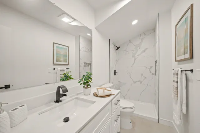 a bathroom with a sink toilet and shower