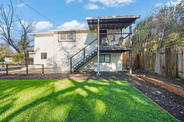 a house view with a sitting space and garden
