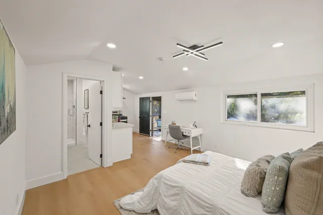 a bedroom with a bed and a chandelier