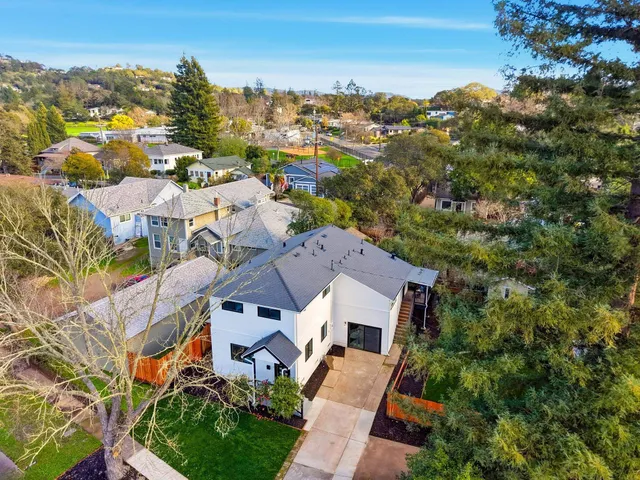an aerial view of residential houses with outdoor space