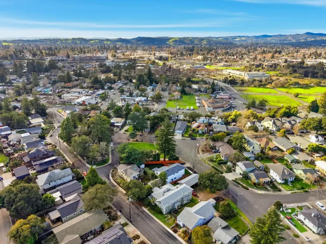 an aerial view of residential houses with outdoor space