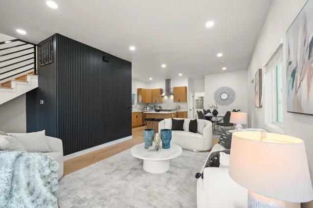 a living room with dining room and kitchen view