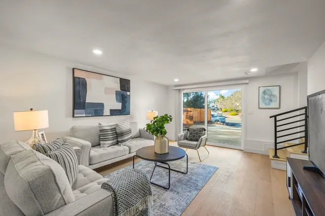 a living room with furniture and a wooden floor