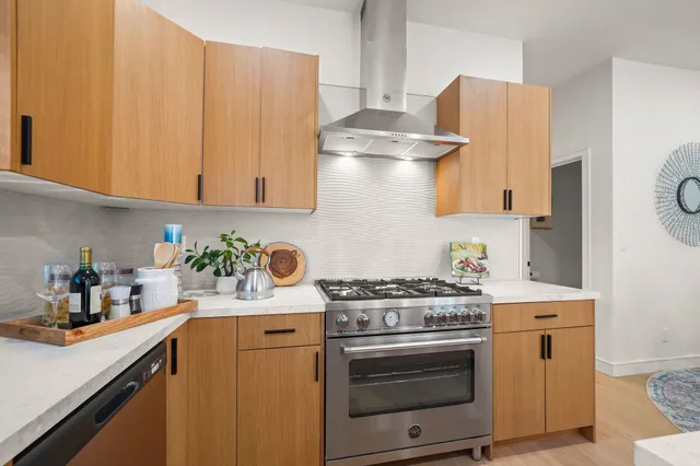 a kitchen with a stove and a white refrigerator