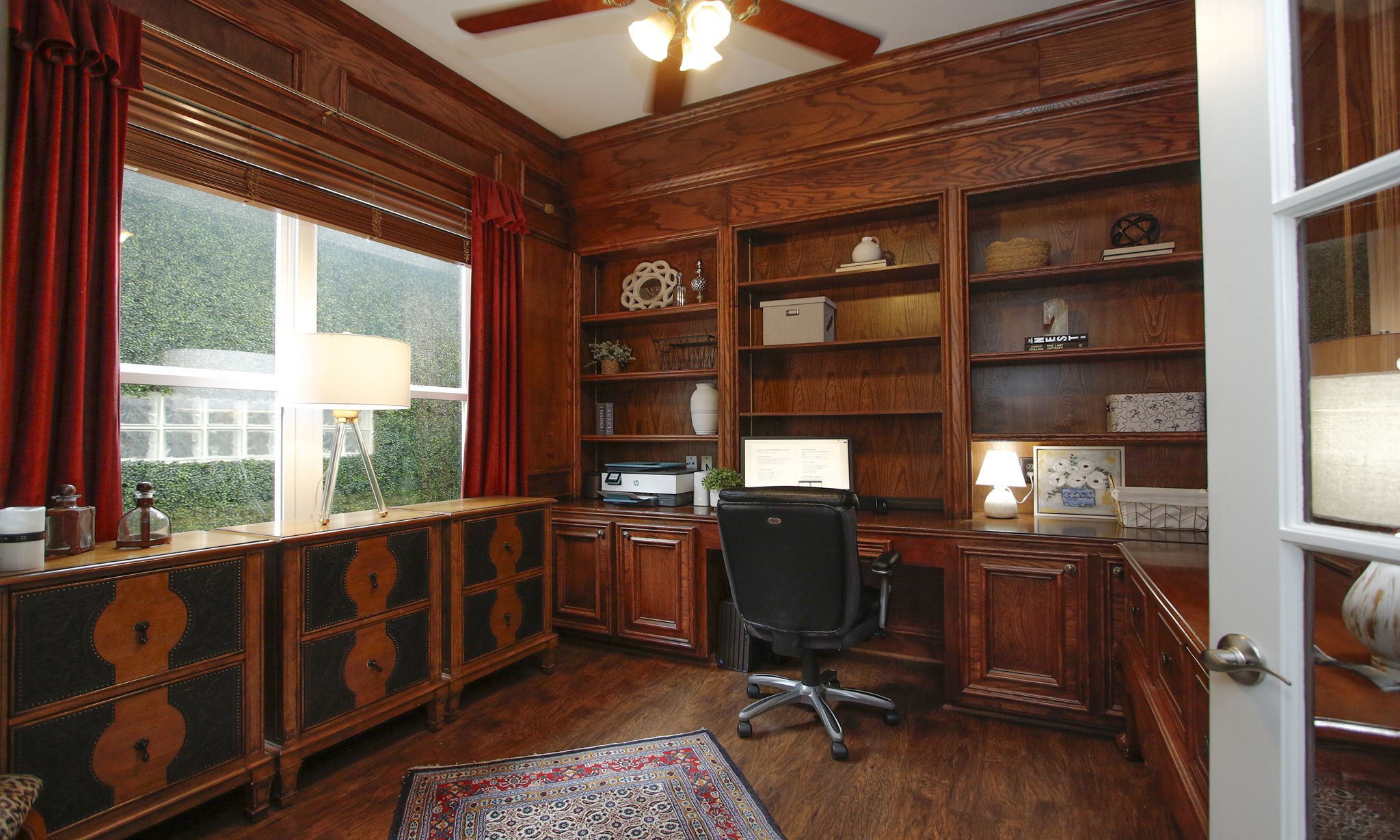 16610 Manningtree Lane Spring, TX 77379 - Photo 30 of 50 The home office is so functional with custom shelves and luxury laminated flooring. Notice the view out the window.