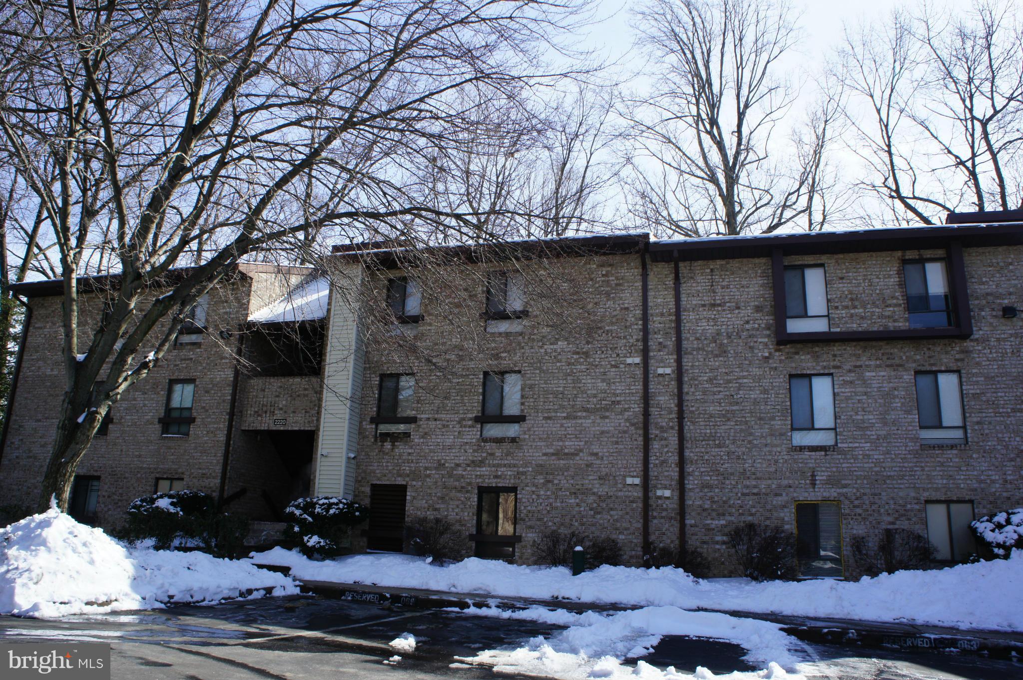 2220 Castle Rock Square, Unit 12C Reston, VA 20191 - Photo 1 of 16 a front view of a house with a yard
