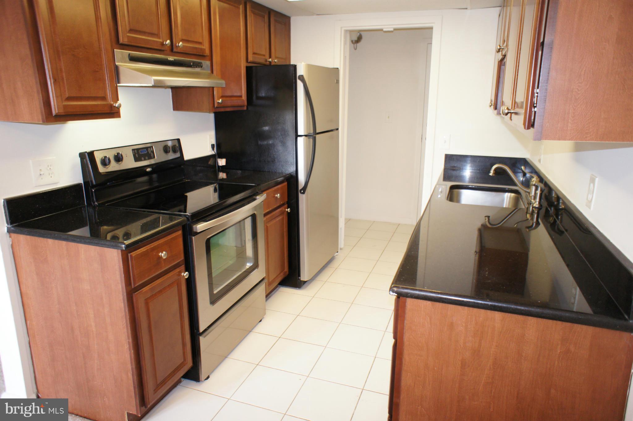 2220 Castle Rock Square, Unit 12C Reston, VA 20191 - Photo 3 of 16 a kitchen with stainless steel appliances granite countertop a refrigerator and a stove