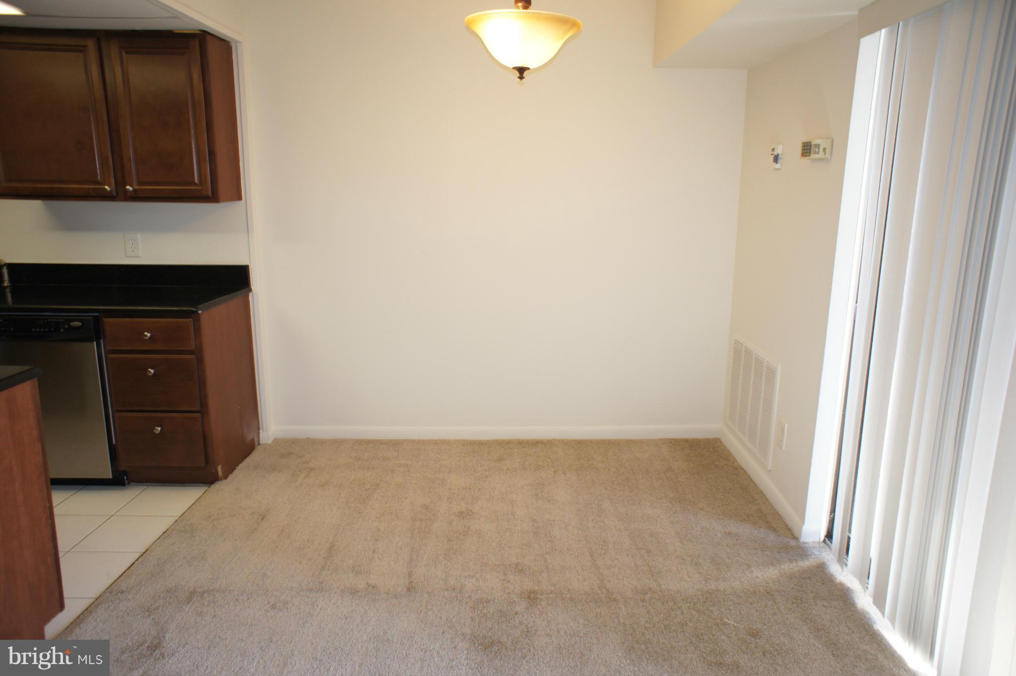 2220 Castle Rock Square, Unit 12C Reston, VA 20191 - Photo 4 of 16 a view of an empty room with a fireplace and a window