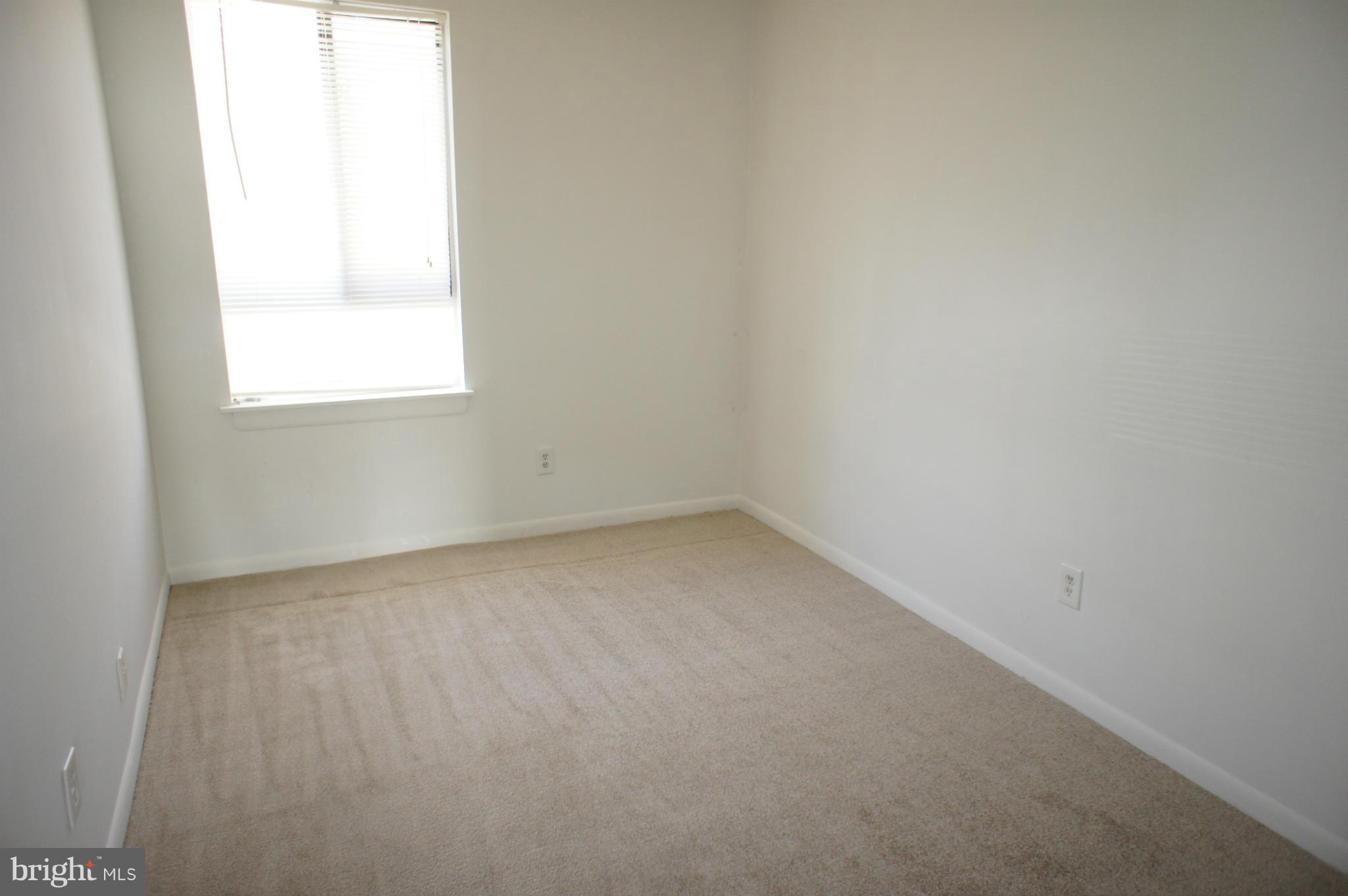 2220 Castle Rock Square, Unit 12C Reston, VA 20191 - Photo 8 of 16 an empty room with a window