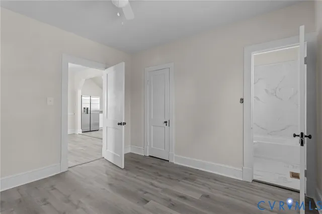 a view of a hallway with wooden floor
