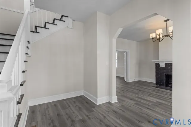 wooden floor in an empty room with a fireplace