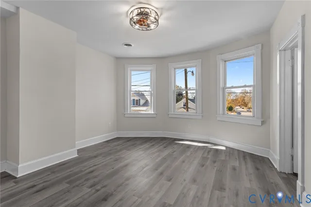 wooden floor in an empty room with a window