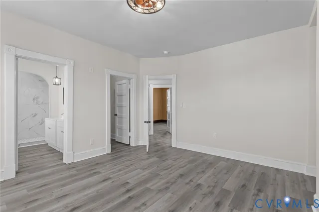 a view of an empty room with wooden floor
