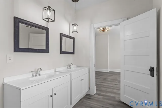 a bathroom with a double vanity sink a mirror and a shower