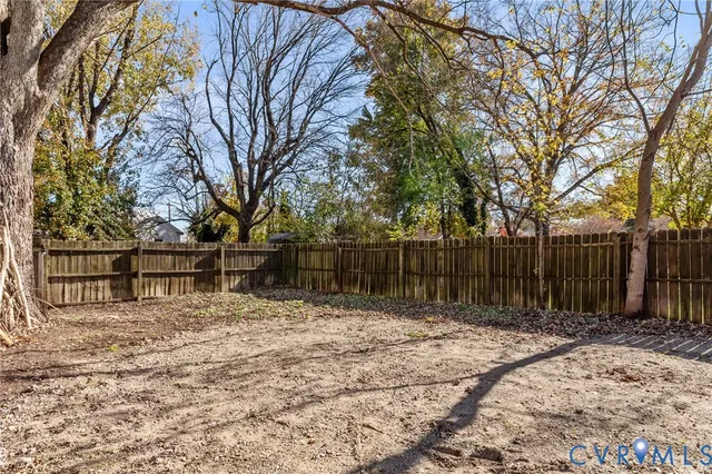 a view of a house with wooden fence
