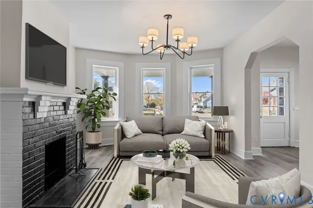 a living room with furniture a fireplace and a flat screen tv