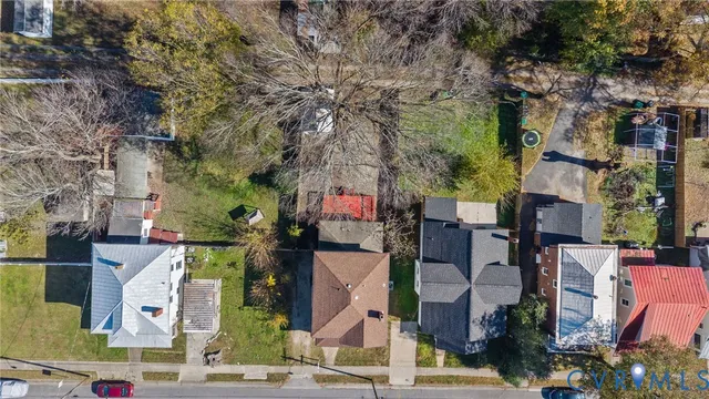 an aerial view of a house with a yard potted plants and large tree