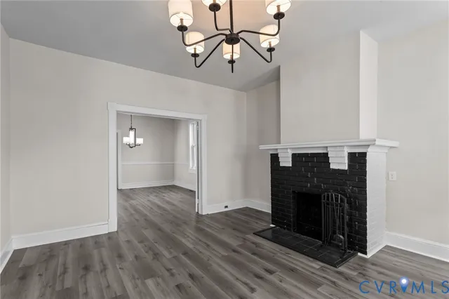 a view of a livingroom with a fireplace and wooden floor