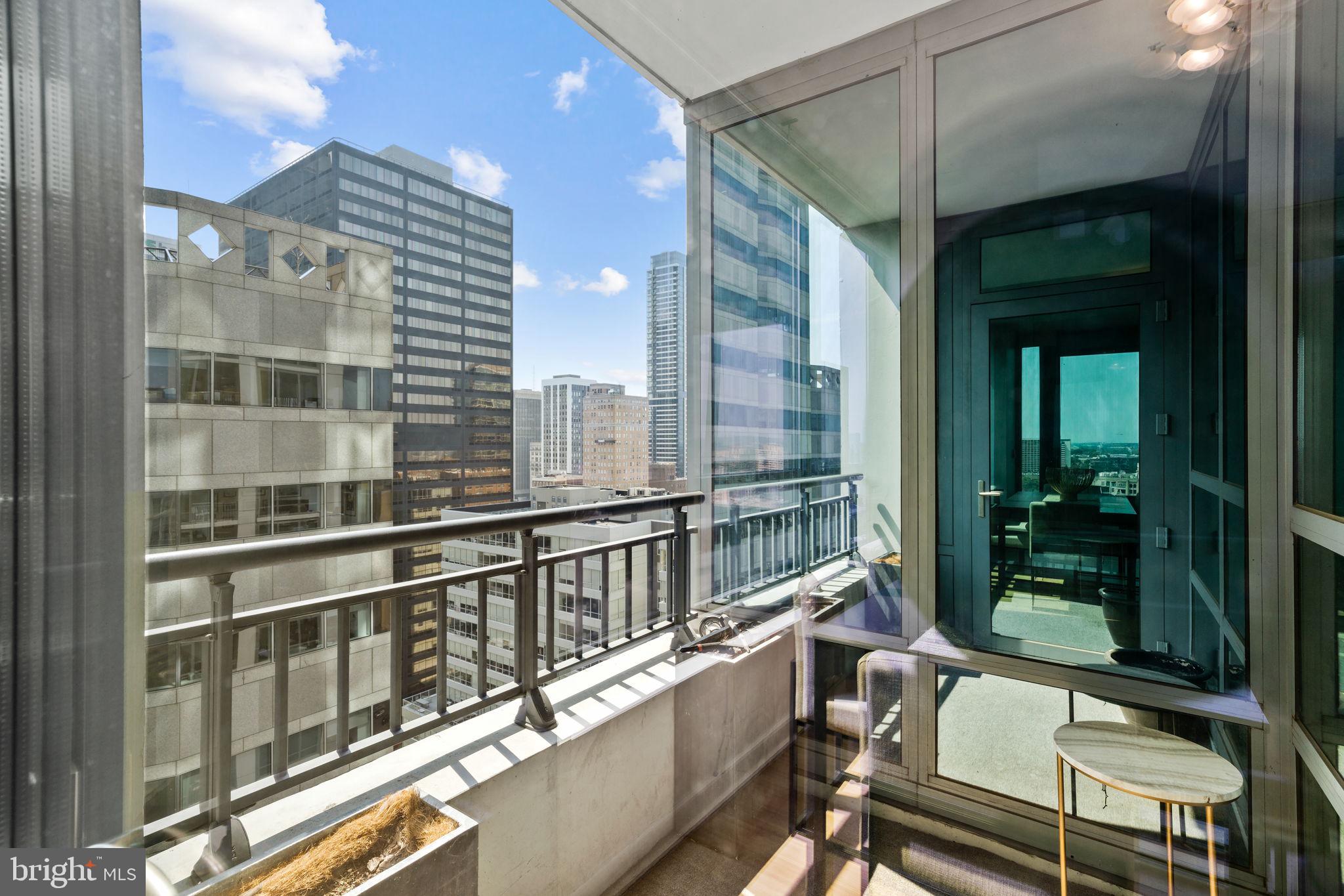 2101 Market Street, Unit 2007 Philadelphia, PA 19103 - Photo 14 of 45 a view of a balcony with a large window and wooden floor