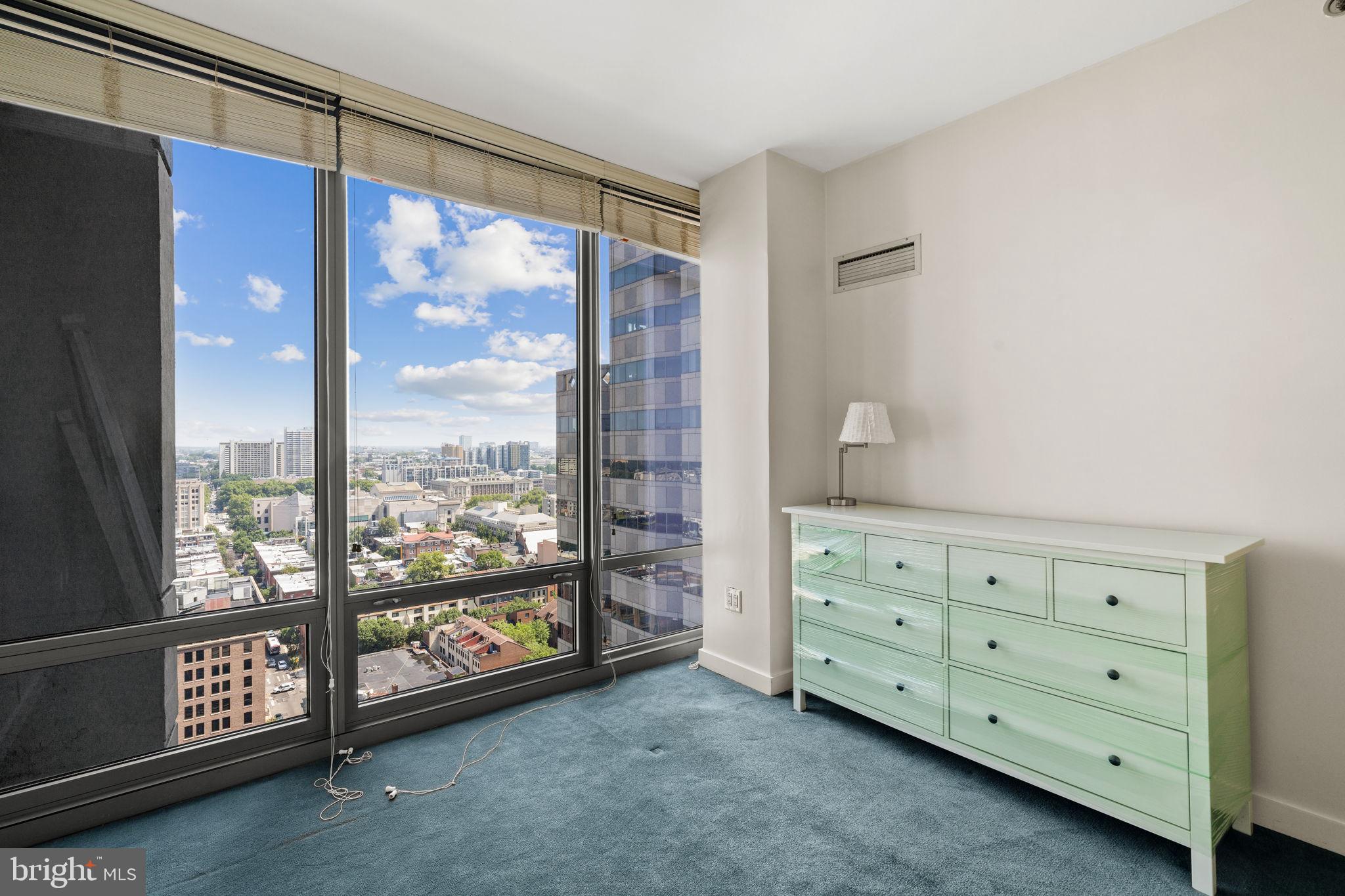 2101 Market Street, Unit 2007 Philadelphia, PA 19103 - Photo 20 of 45 a view of a bedroom with furniture and windows