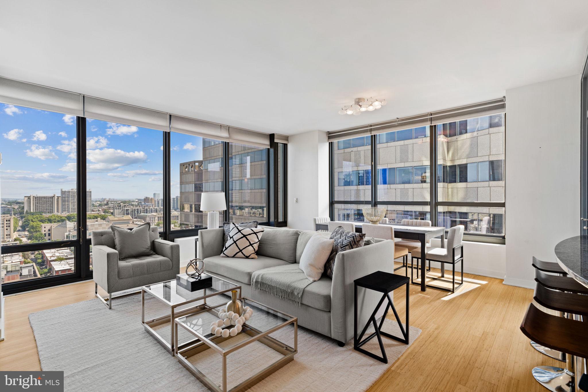 2101 Market Street, Unit 2007 Philadelphia, PA 19103 - Photo 2 of 45 a living room with furniture and a large window