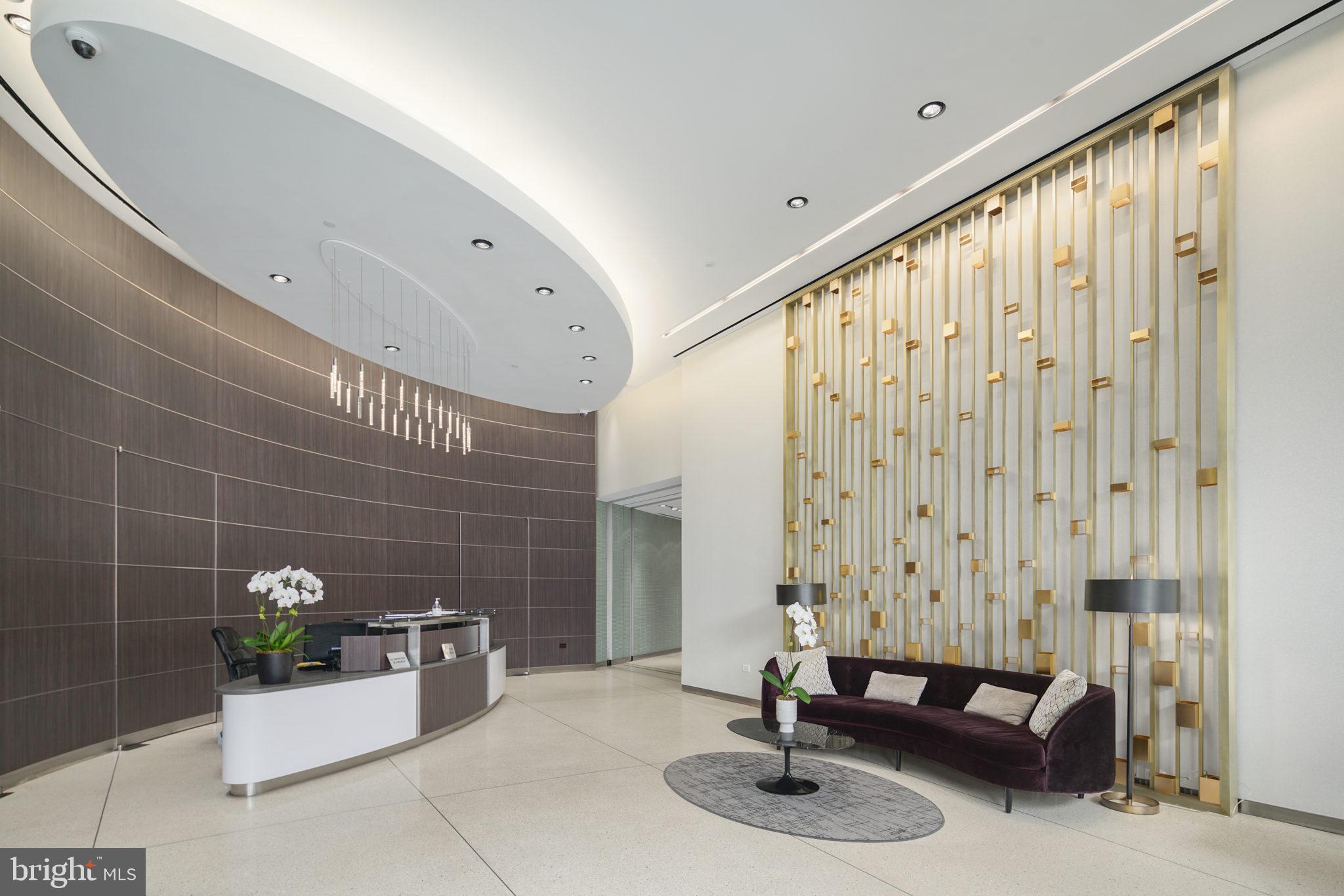 2101 Market Street, Unit 2007 Philadelphia, PA 19103 - Photo 34 of 45 a bathroom with a granite countertop sink a mirror and shower