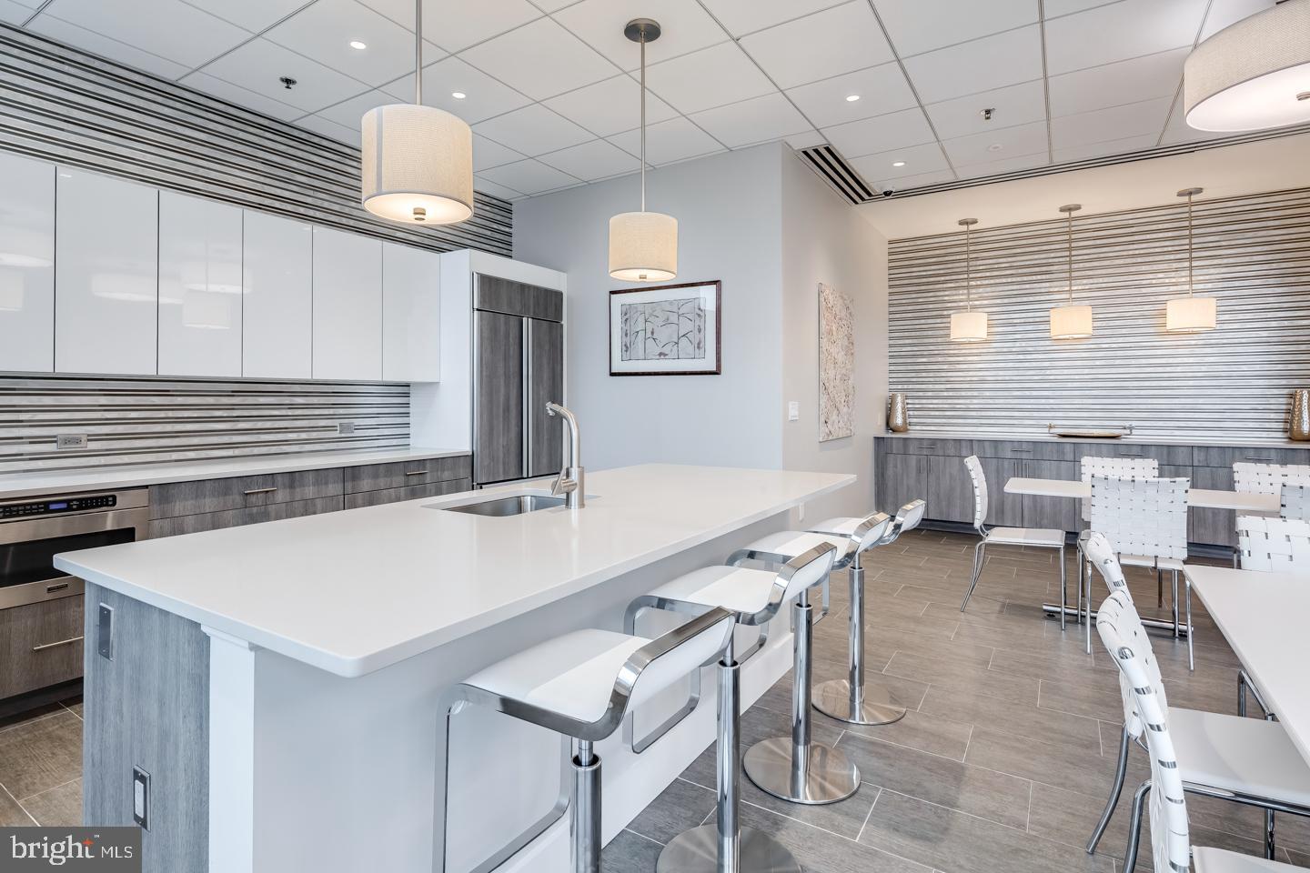 2101 Market Street, Unit 2007 Philadelphia, PA 19103 - Photo 44 of 45 a large kitchen with a table and chairs