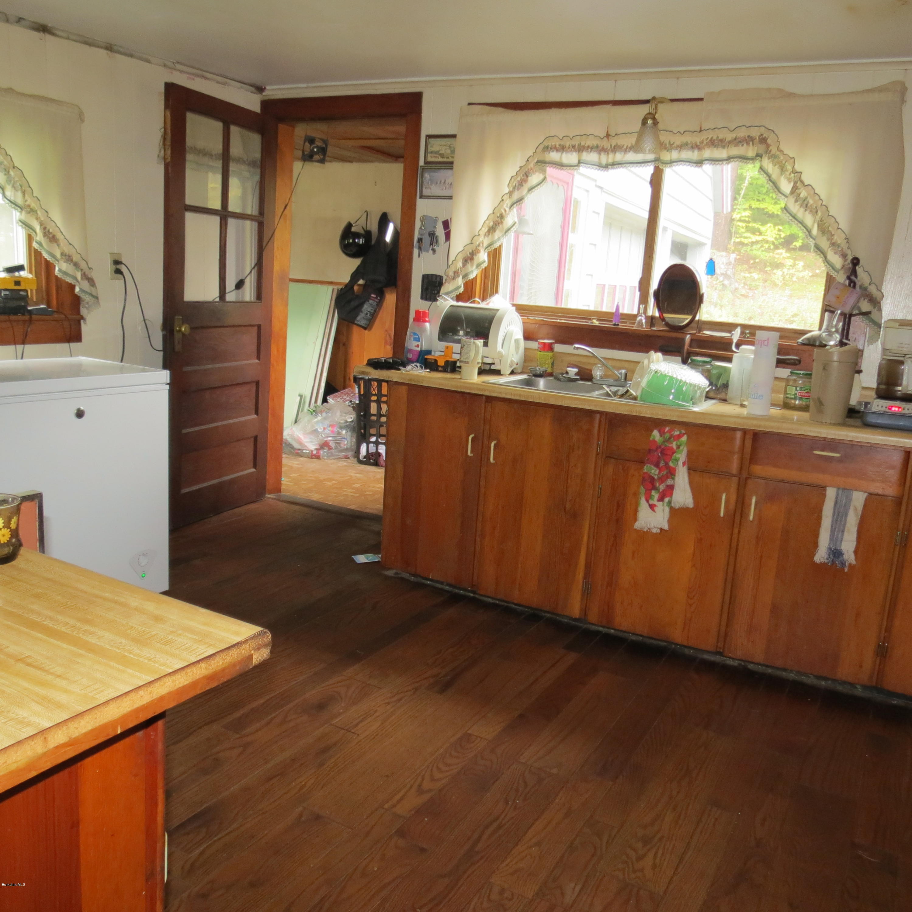 4733 Main Road Stamford, VT 05352 - Photo 8 of 39 a kitchen with a wooden floor and a large window