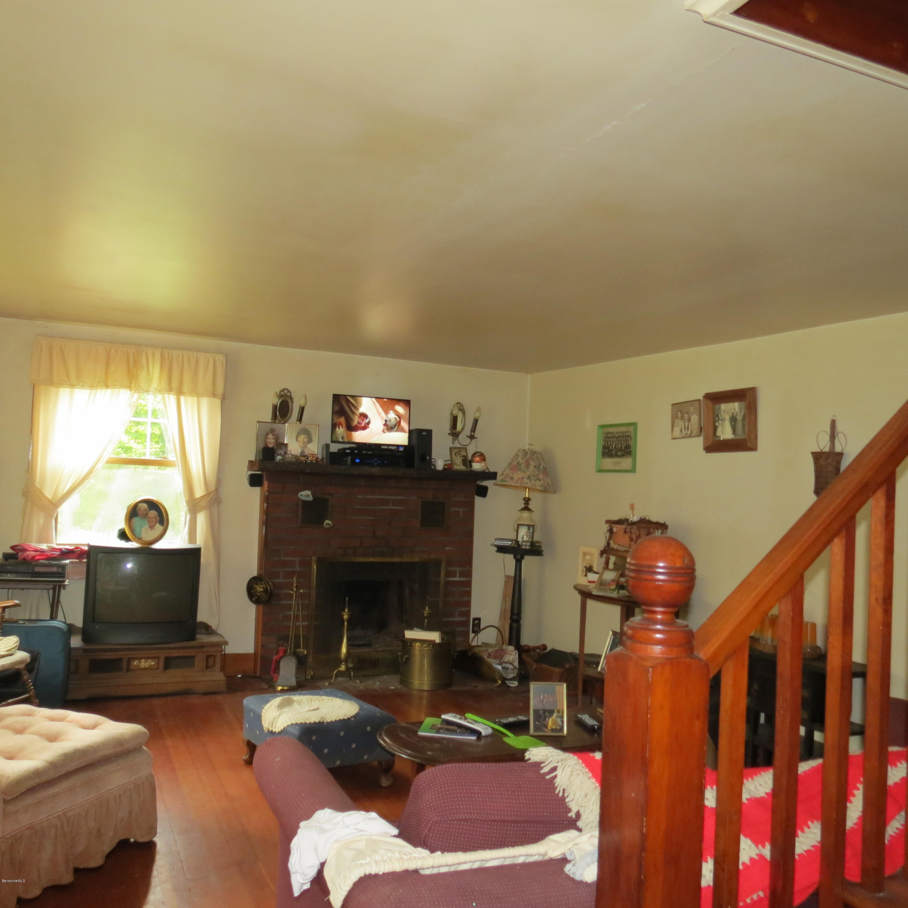 4733 Main Road Stamford, VT 05352 - Photo 9 of 39 a living room with furniture a fireplace and a large window