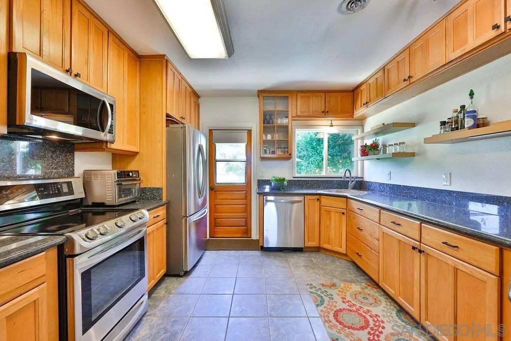 1305 Ashley Road Ramona, CA 92065 - Photo 14 of 72 a kitchen with stainless steel appliances a stove a sink and a microwave