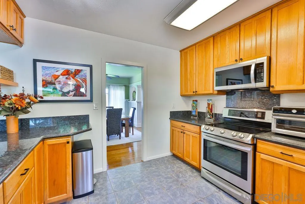 1305 Ashley Road Ramona, CA 92065 - Photo 16 of 72 a kitchen with stainless steel appliances granite countertop a stove a sink and a microwave