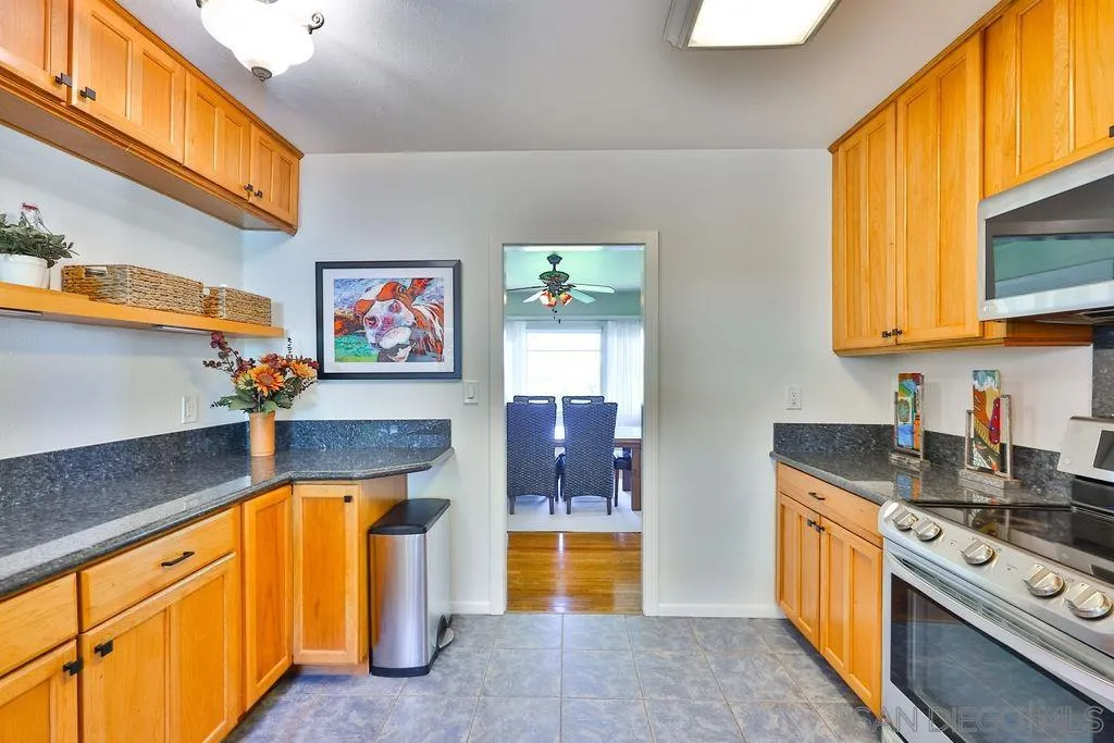 1305 Ashley Road Ramona, CA 92065 - Photo 17 of 72 a kitchen with stainless steel appliances granite countertop a stove a sink and a microwave
