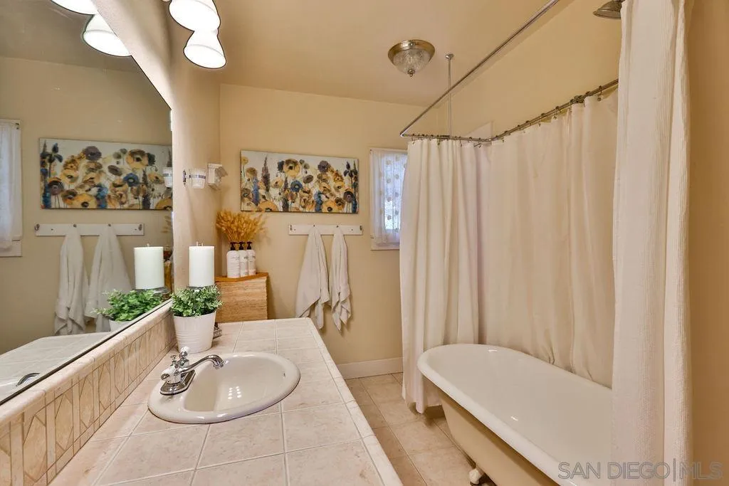 1305 Ashley Road Ramona, CA 92065 - Photo 21 of 72 a bathroom with a sink a mirror and a bathtub