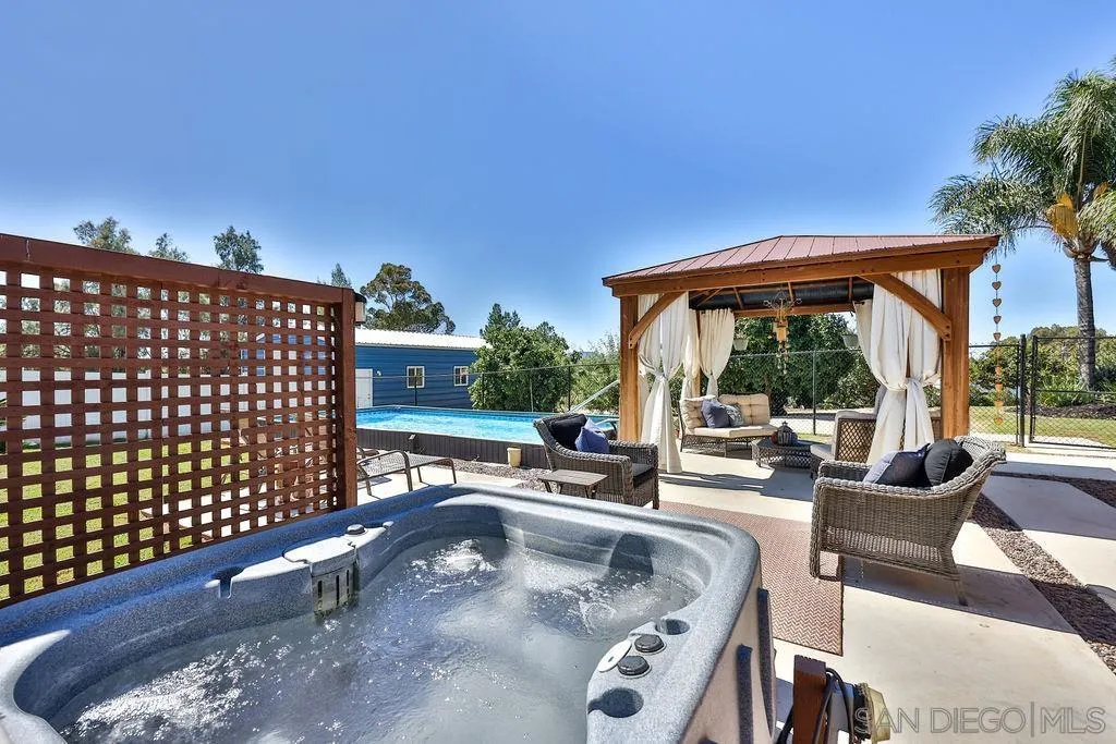 1305 Ashley Road Ramona, CA 92065 - Photo 35 of 72 a view of a patio with couches chairs and potted plants