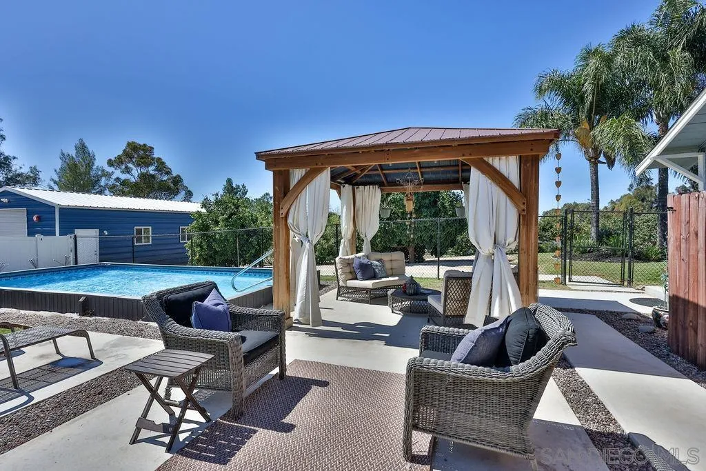 1305 Ashley Road Ramona, CA 92065 - Photo 37 of 72 a view of a patio with couches chairs and potted plants