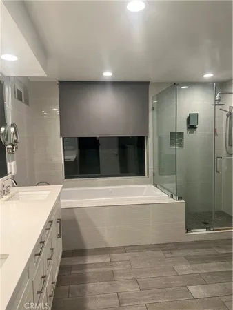 a spacious bathroom with a bathtub and a shower