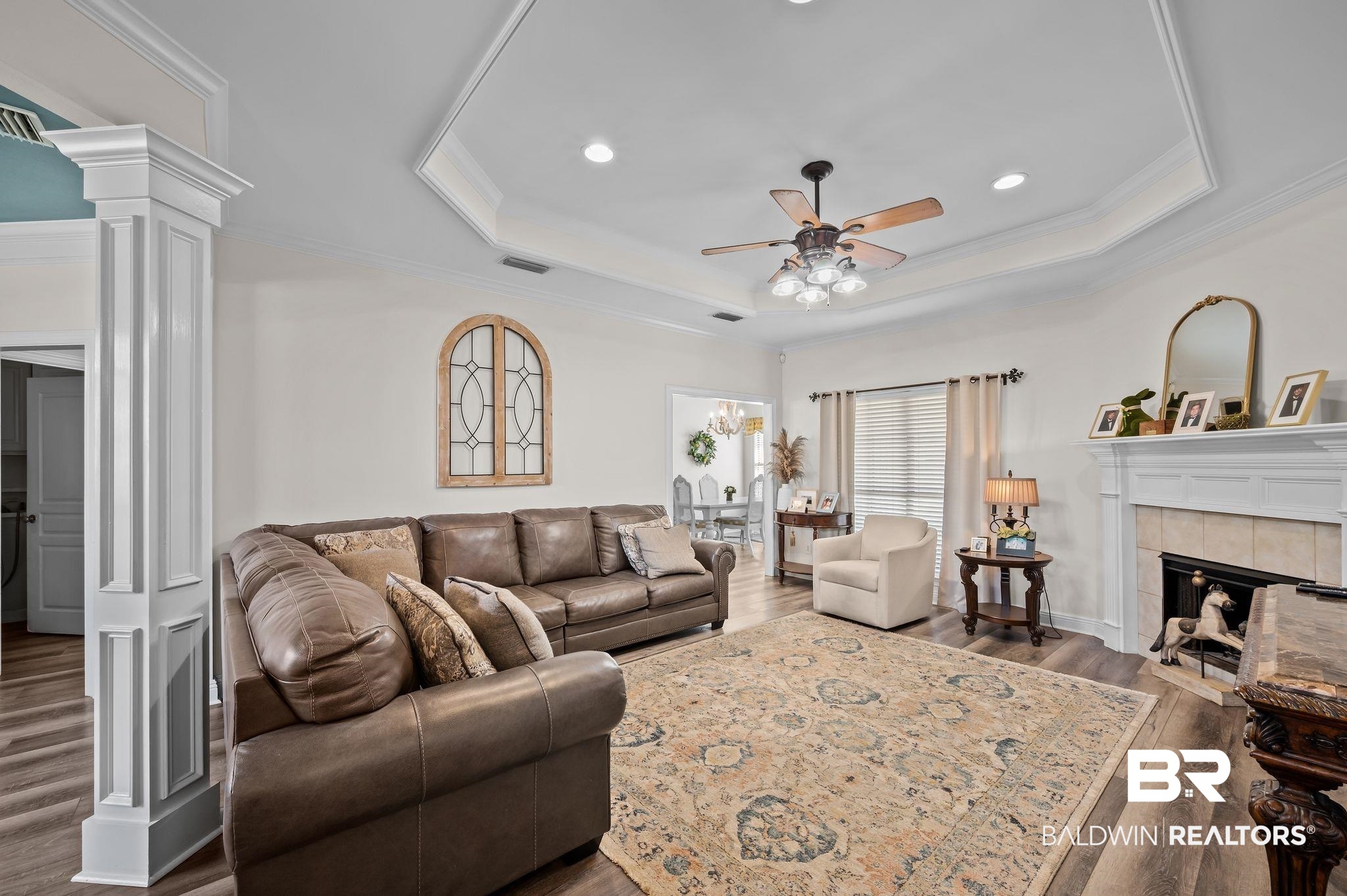 9837 Harmony Ridge Drive Semmes, AL 36575 - Photo 8 of 29 Living area with visible vents, a ceiling fan, wood finished floors, and a raised ceiling