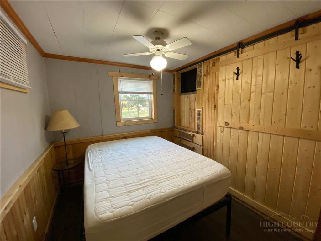 143 Ridge Crest Drive West Jefferson, NC 28694 - Photo 5 of 9 a bedroom with a bed and a chandelier